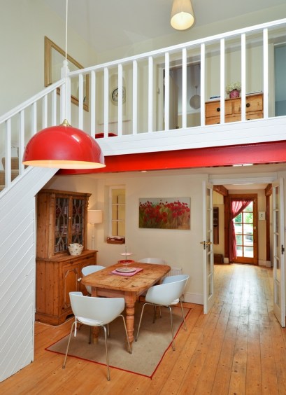 Dining Area in a Claddagh House with wooden floors, a wooden table and white chairs